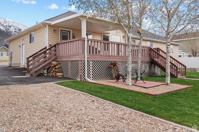 Back of property featuring a yard, stairway, and a mountain view | Image 32