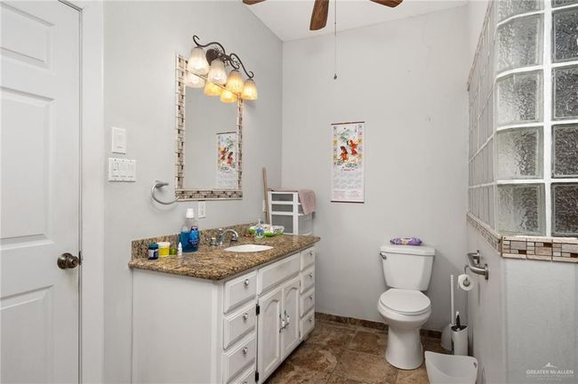 Bathroom featuring ceiling fan, vanity, tile patterned flooring, and toilet | Image 11