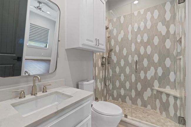 Full bathroom with a shower stall, toilet, and vanity | Image 14