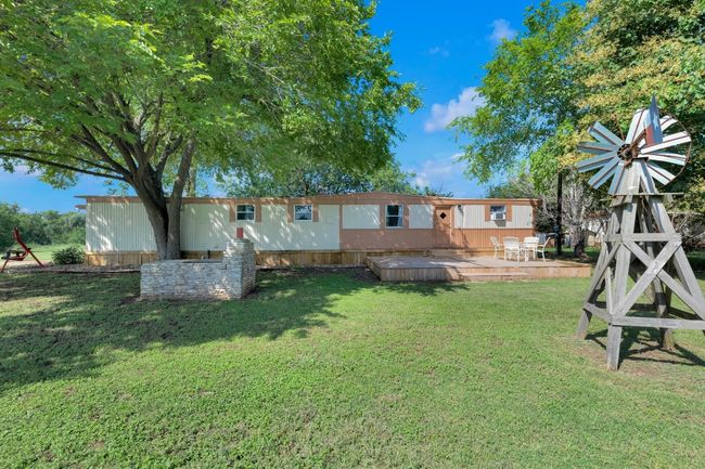 View of green lawn featuring a deck | Image 34