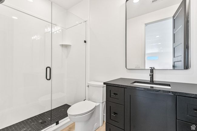 Full bathroom with toilet, a shower stall, vanity, and wood finished floors | Image 53