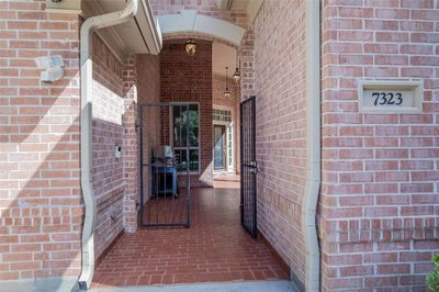 Private wrought iron gates entrance open to a covered entryway leading to with its own private courtyard & CASITA and the front door. | Image 2