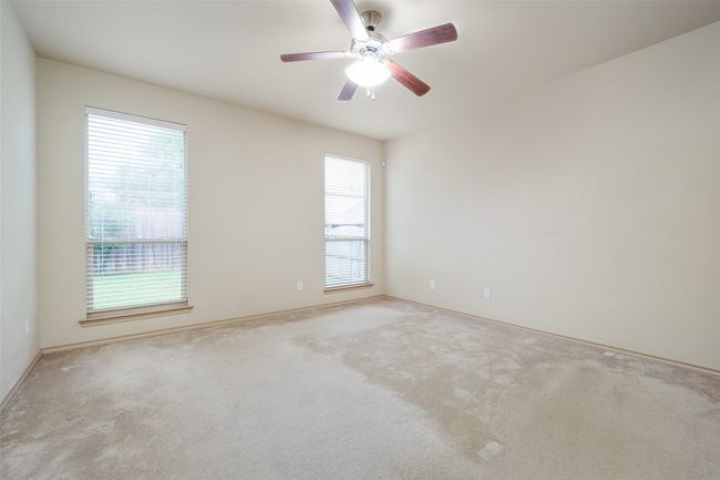 Empty room with carpet floors and ceiling fan | Image 11