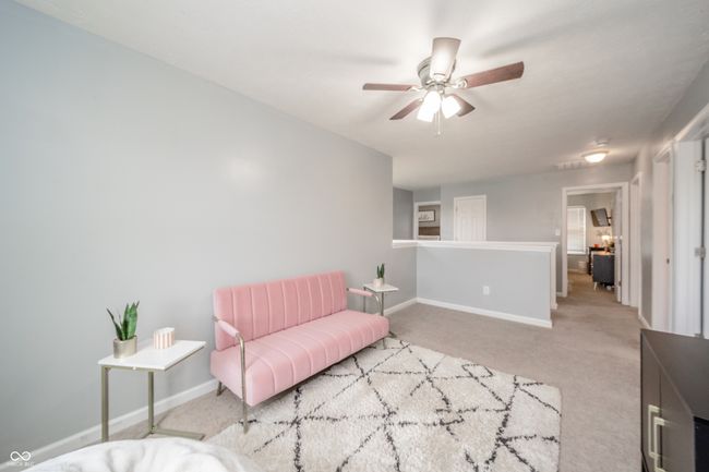 living area with carpet flooring, baseboards, and a ceiling fan | Image 24