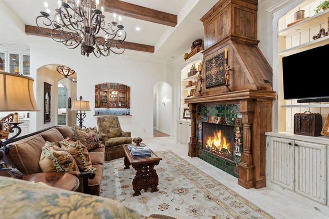 The custom-designedgas log fireplace withremote start is a nearreplica of an originalfireplace reclaimed from France. | Image 8
