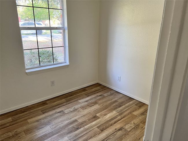 Spare room featuring baseboards and wood finished floors | Image 7