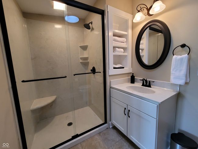 Upstairs bath with walk-in shower and skylight. | Image 63
