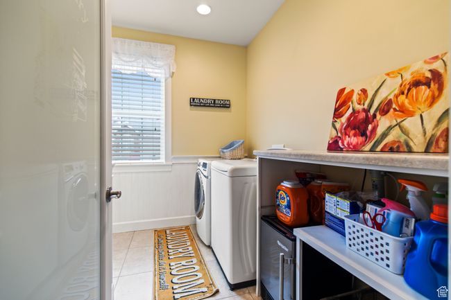 Washroom featuring washing machine and dryer and light tile patterned floors | Image 52