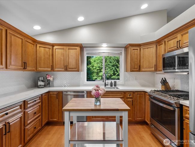 Spacious updated kitchen with movable island | Image 10