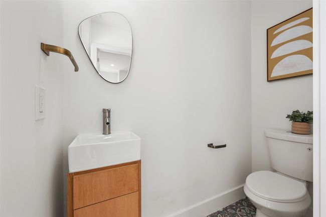 Half bathroom featuring baseboards, toilet, and vanity | Image 17