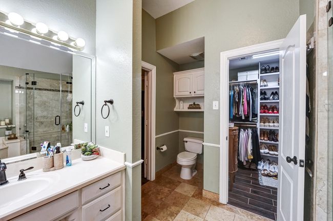 Bathroom featuring toilet, a stall shower, vanity, and a spacious closet | Image 25