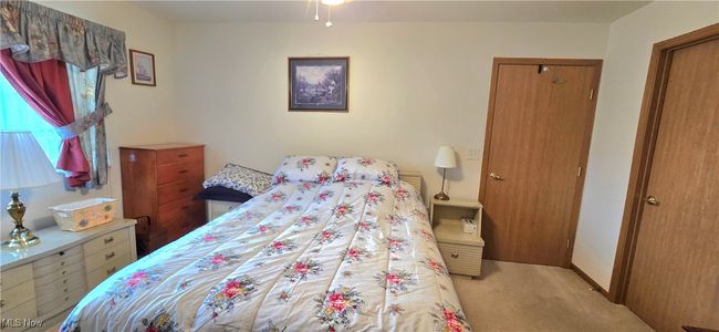 Carpeted bedroom with a closet and baseboards | Image 15