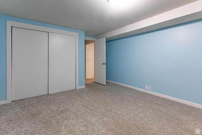 Unfurnished bedroom featuring carpet, baseboards, and a closet | Image 27