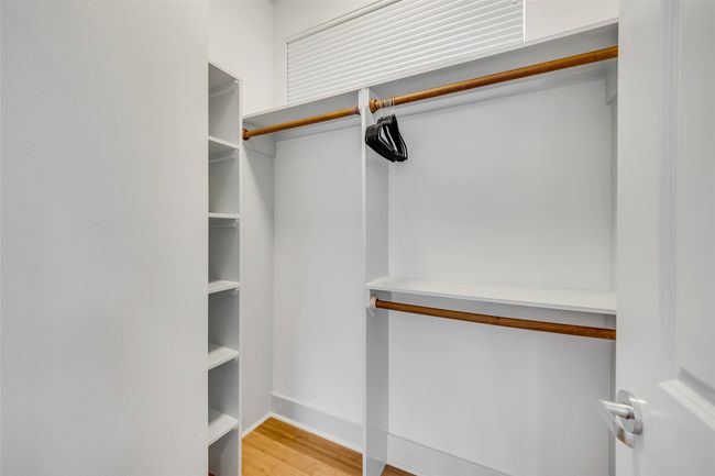 Walk in closet with light hardwood / wood-style flooring | Image 28