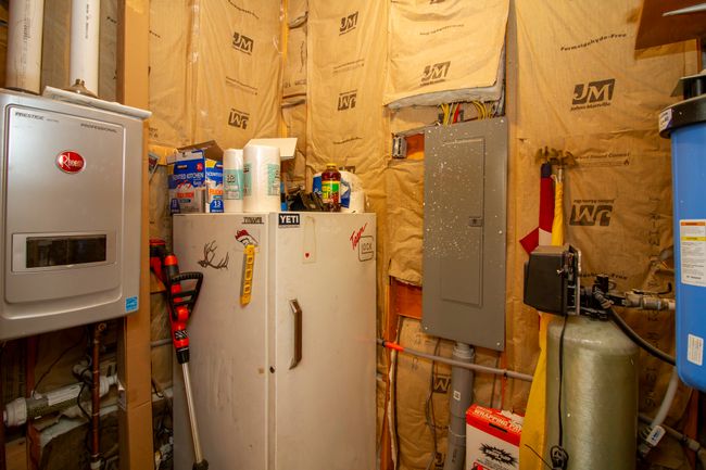 Utility room with electric panel and on demand water heater | Image 13
