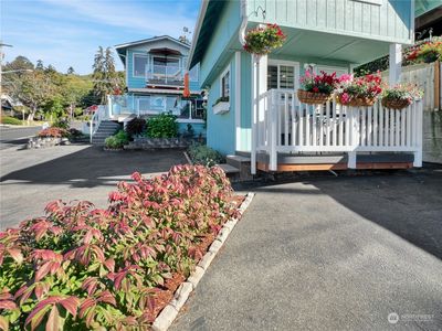 Main house in the background with the ADU (cottage) in the foreground with off street parking for 4 cars. | Image 1