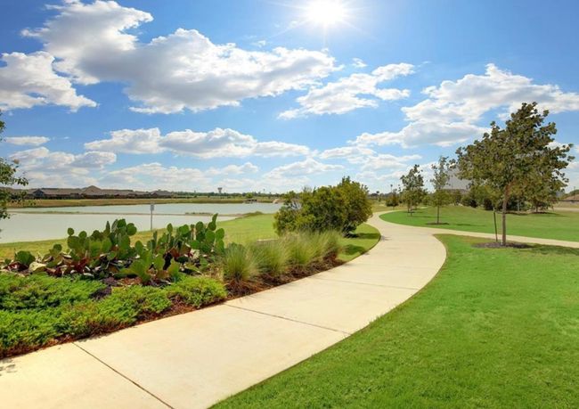 View of community featuring a yard and a water view | Image 38