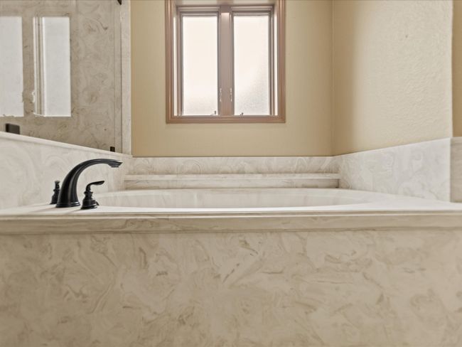 Master Bathroom with a tub with marble appearance | Image 27