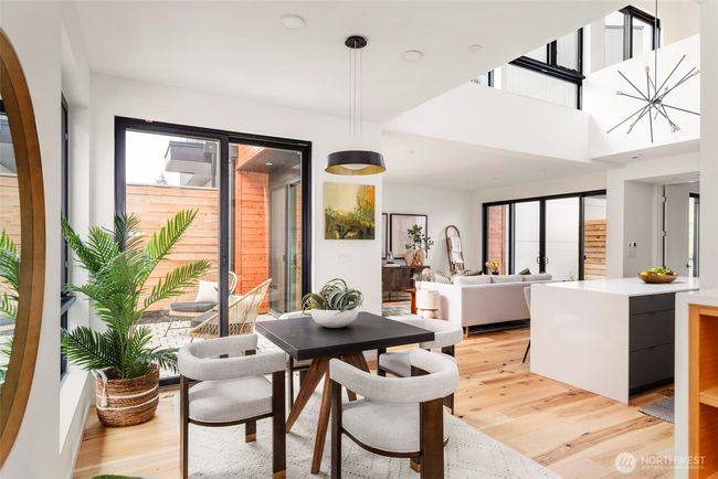The dining space is bathed in natural light and seamlessly connects to the outdoors, offering the perfect setting for indoor-outdoor living. | Image 4