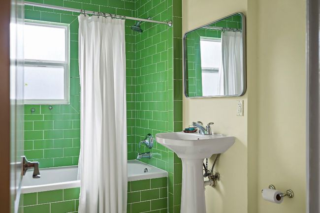 Full bathroom featuring tiled shower / bath, a sink, and a wealth of natural light | Image 23