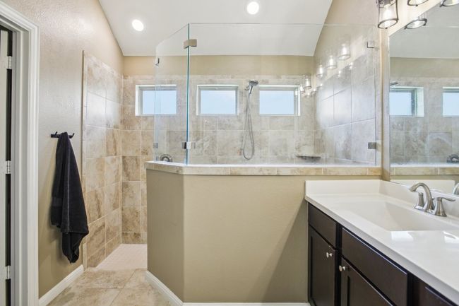 Full bath with plenty of natural light, vanity, and a walk in shower | Image 17