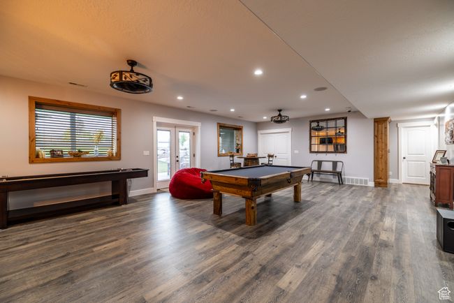 Playroom with dark wood-style flooring, pool table, french doors, and recessed lighting | Image 53