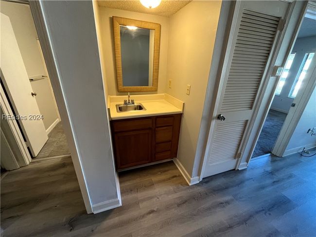 Bathroom with vanity, a textured ceiling, and wood-type flooring | Image 4