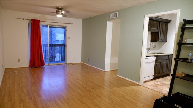 Living/dining combo room with light wood-type flooring, ceiling fan, and sink | Image 6