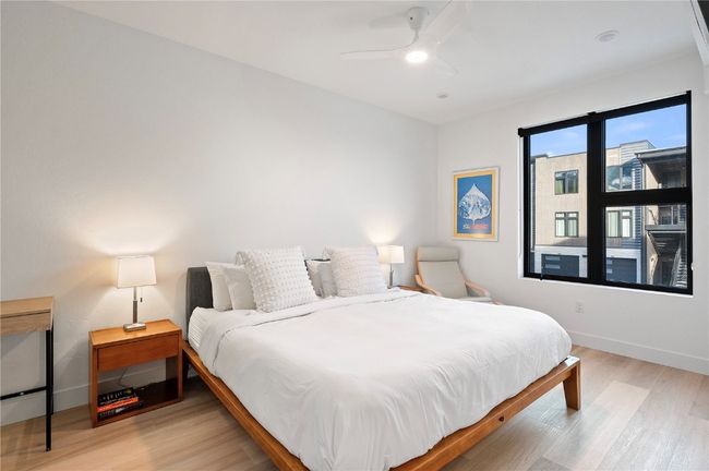 Bedroom with ceiling fan and light wood-type flooring | Image 17