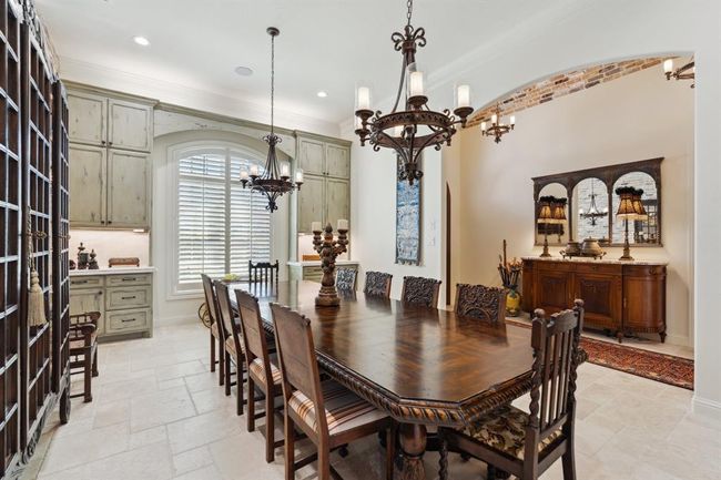 Two custom-designed, faux-finish, floor-to-ceiling cabinetsflank the large arched front window. | Image 5