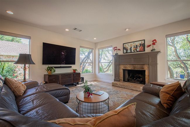 Living room featuring healthy amount of natural light, baseboards, recessed lighting, and a high end fireplace | Image 15