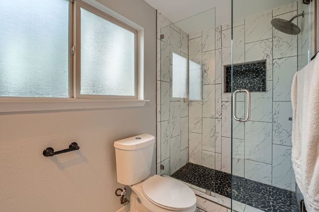 Bathroom featuring toilet and a stall shower | Image 18
