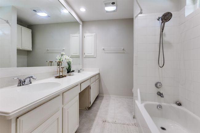 Bathroom with double vanity, shower / bathtub combination, and tile patterned flooring | Image 21
