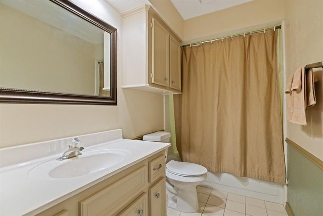 Enjoy a full-size bathroom upstairs, complete with cabinet storage, shower, and full tub. | Image 32