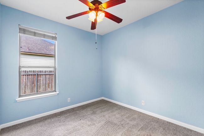Unfurnished room with carpet and a ceiling fan | Image 23