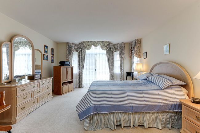 Bedroom with light colored carpet | Image 26