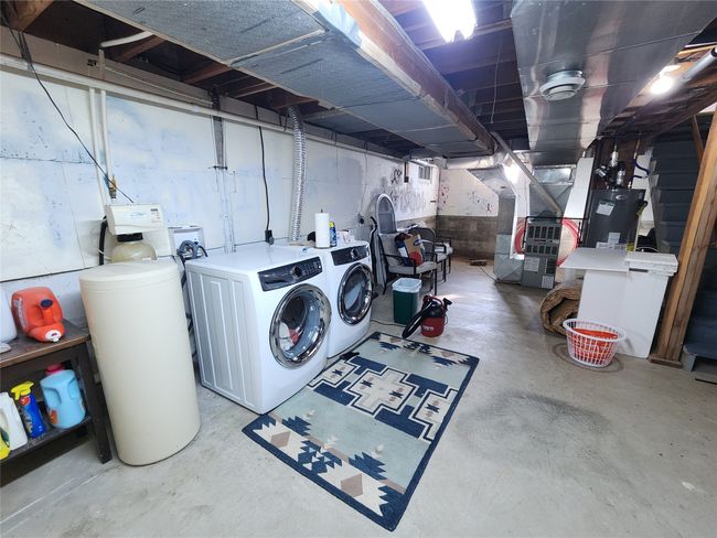 Clothes washing area with water heater, washing machine and dryer, and laundry area | Image 41