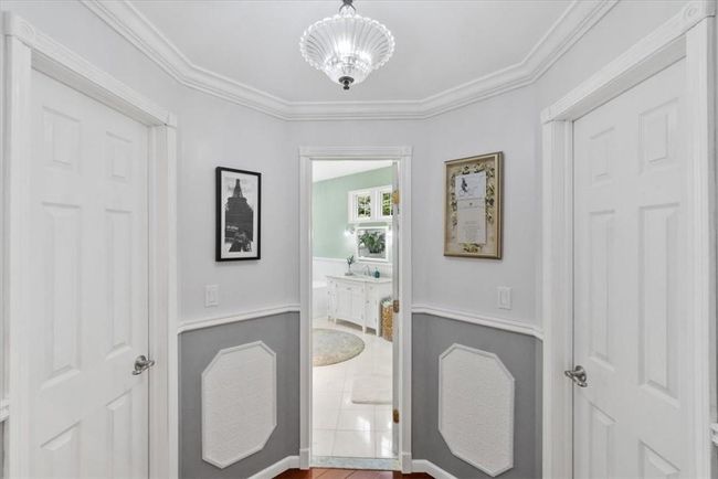 Dressing area including 2 walk in closets. Custom moldings. | Image 24