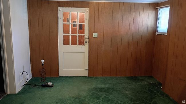 Empty room featuring wood walls and dark carpet | Image 51