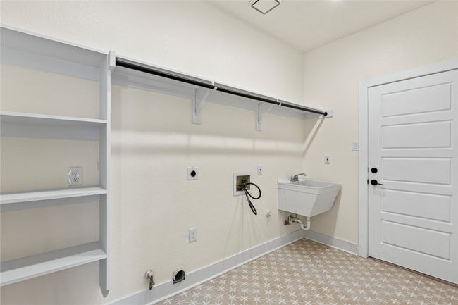 Laundry room featuring hookup for a gas dryer, hookup for a washing machine, electric dryer hookup, and light flooring | Image 13