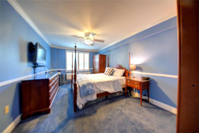 Bedroom with carpet, ornamental molding, ceiling fan, and baseboards | Image 15