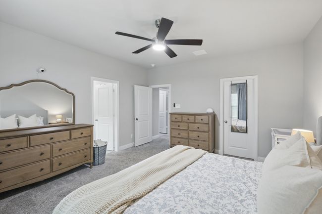 Carpeted bedroom featuring ceiling fan and baseboards | Image 12
