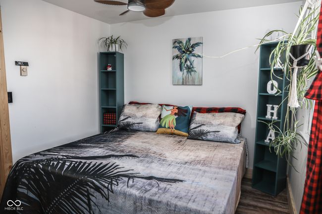 bedroom with wood finished floors and ceiling fan | Image 6