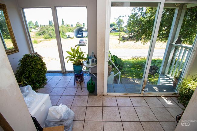Doorway to outside featuring tile patterned flooring | Image 11