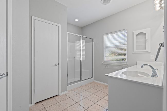 Full bathroom with a stall shower, tile patterned floors, and double vanity | Image 14