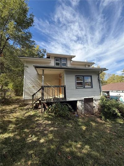 Rear view of house with a deck and a yard | Image 2