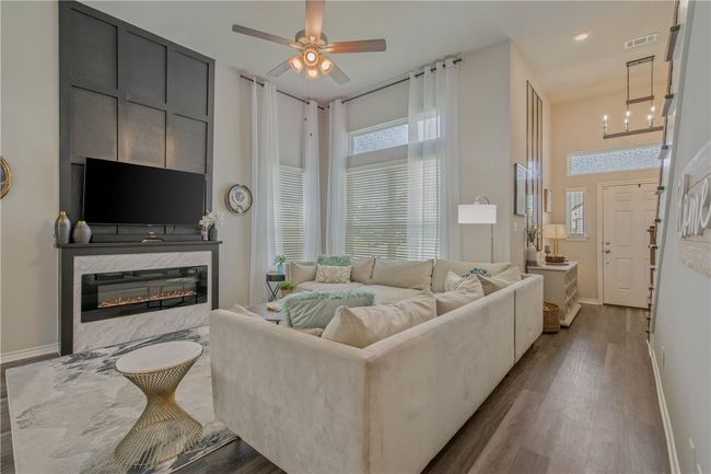 Living room featuring dark wood finished floors and healthy amount of natural light | Image 8