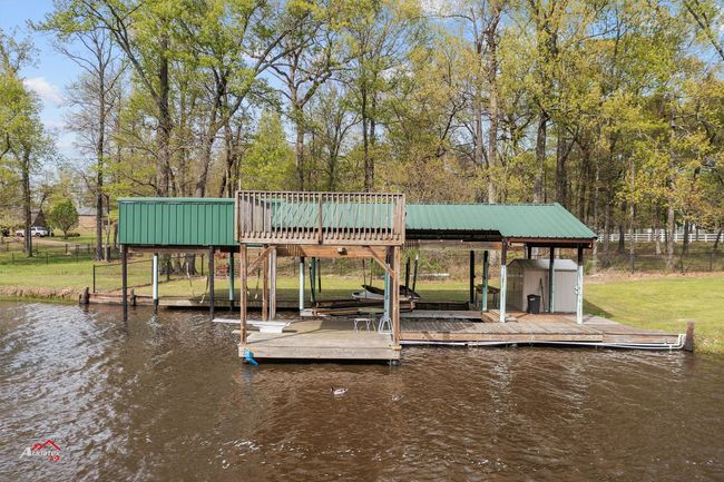 Boathouse with ample deck for fishing and swimming. | Image 16