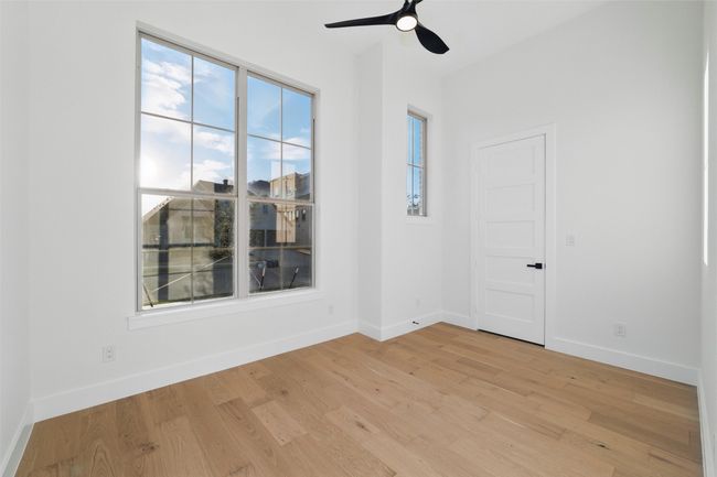 Spare room with baseboards, light wood-style flooring, and ceiling fan | Image 14