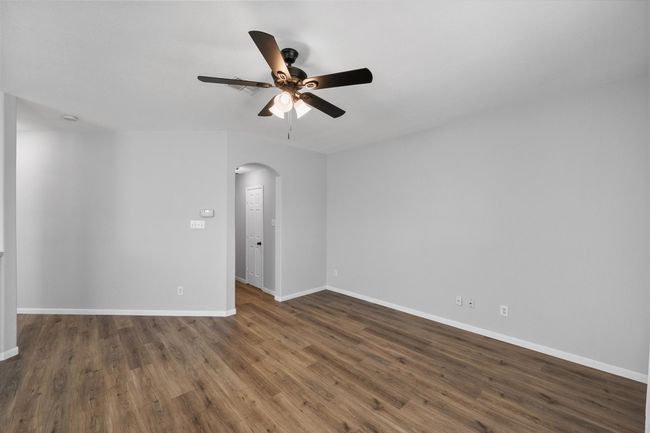 Spare room with arched walkways, ceiling fan, and wood finished floors | Image 21